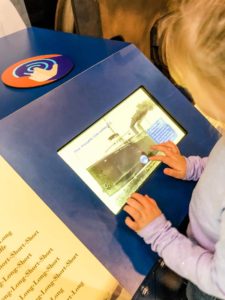 Girl using a tablet display that replicates the different ship whistles. 