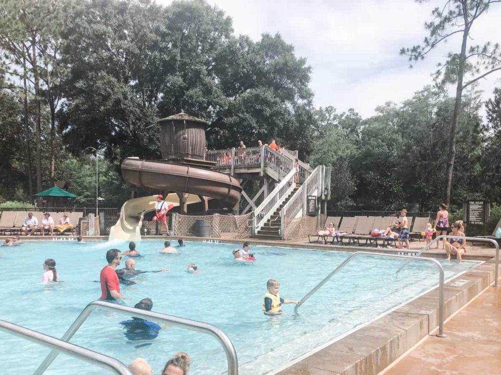 Meadows Pool at Disney's Fort Wilderness. Waterslide in the background that looks like a wooden water tower. 