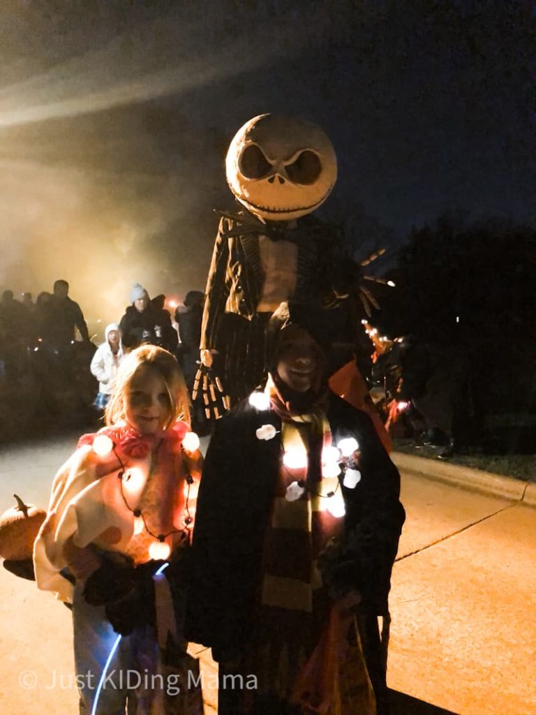 Teenager dressed in Jack Skellington Costume, but very tall because wearing stilts. 
