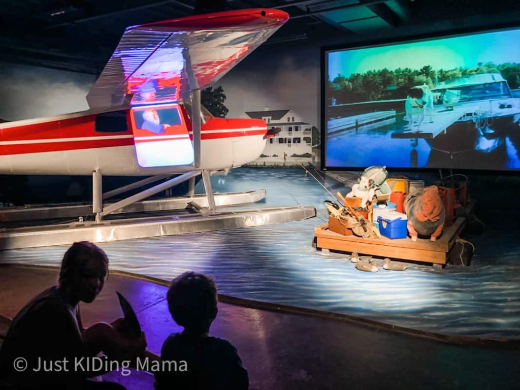 Movie theater inside of the plane museum. Has a red real plane and a fishing dock scene set around the screen.