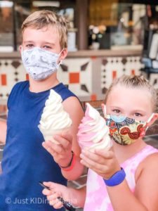 Boy and girl wearing masks holding Dole Whip frozen treats.