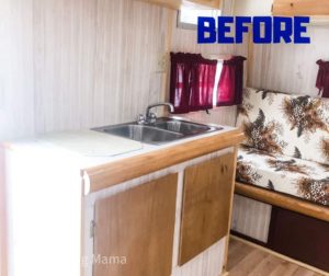 White and natural wood counters in a vintage camper with red curtains and floral pattern couch