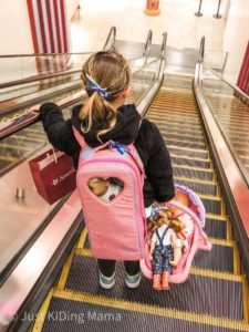 Girl Heading down the escalator with her dolls after a fun day at American Girl Doll Store